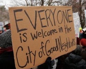 A sign that reads, "Everyone Is welcome in the City of Good Neighbors"